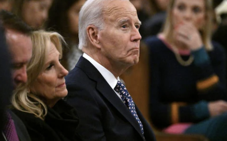 A concerned Joe Biden looks on.